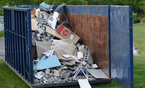 Builders using a skip for construction debris