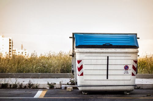 Demolition site in Enfield with waste removal trucks