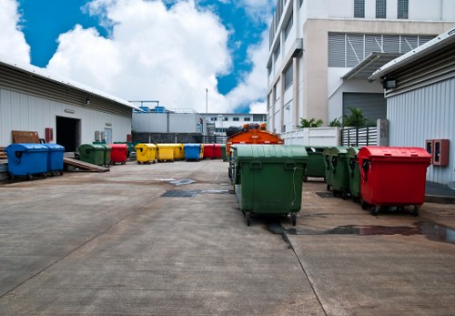 Workers placing a domestic skip on a residential driveway